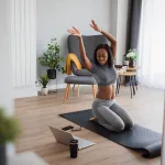 Female athlete exercising at home, doing warming before workout exercises